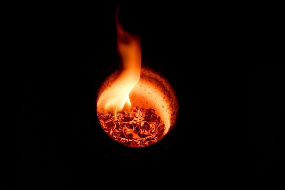 Gold jewelry melts inside a crucible at A&M Precious Metals in the St. Vincent Jewelry Center in the Jewelry District of Los Angeles, Friday, May 2, 2025. (AP Photo/Jae C. Hong)