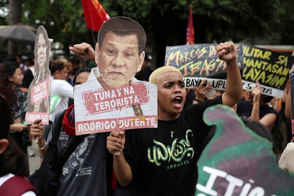 A man holds a sign against former Philippine President Rodrigo Duterte during a protest in Manila, the Philippines, on Friday. March 28, 2025 (AP)