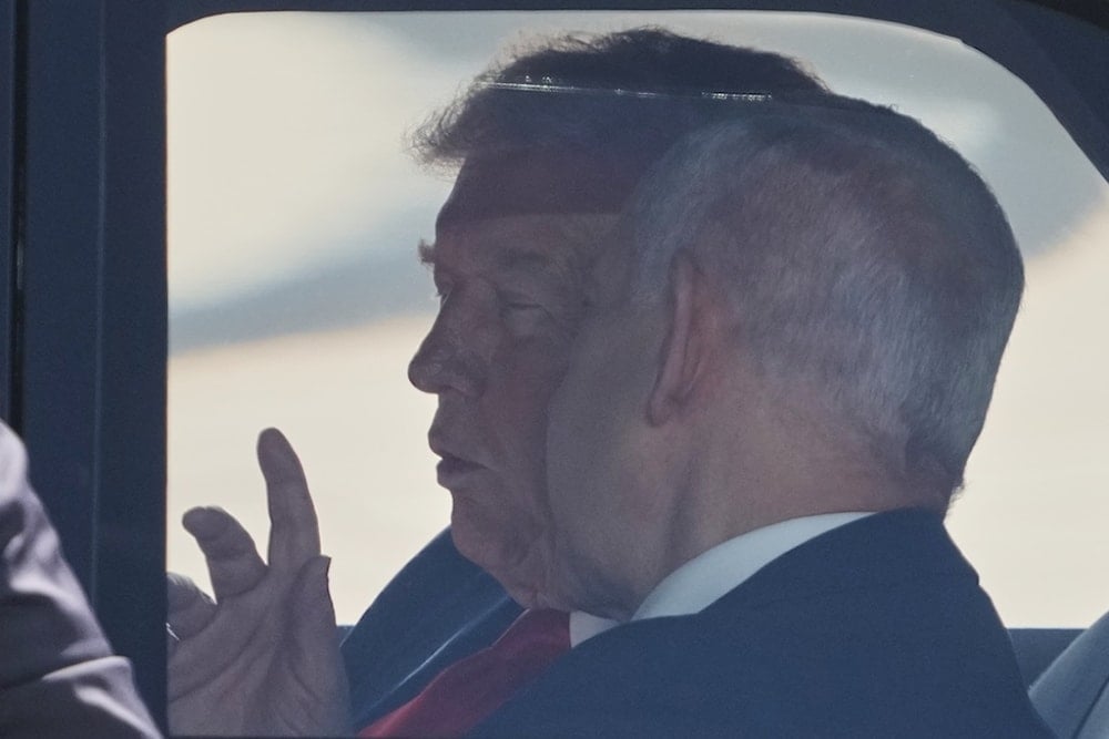 President Donald Trump speaks with Israeli Prime Minister Benjamin Netanyahu as they sit together in a car after a welcoming ceremony at Ben Gurion Airport near Tel Aviv, occupied Palestine, Monday, October 13, 2025 (AP)