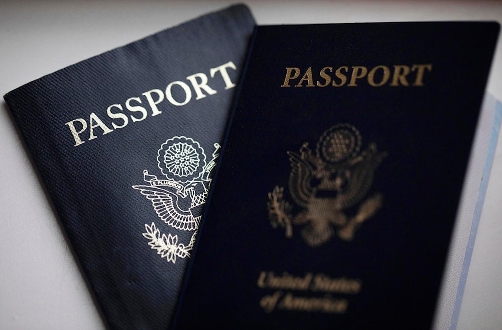 US passports are arranged for a photograph in Tigard, Ore., on Dec. 11, 2021 (AP)