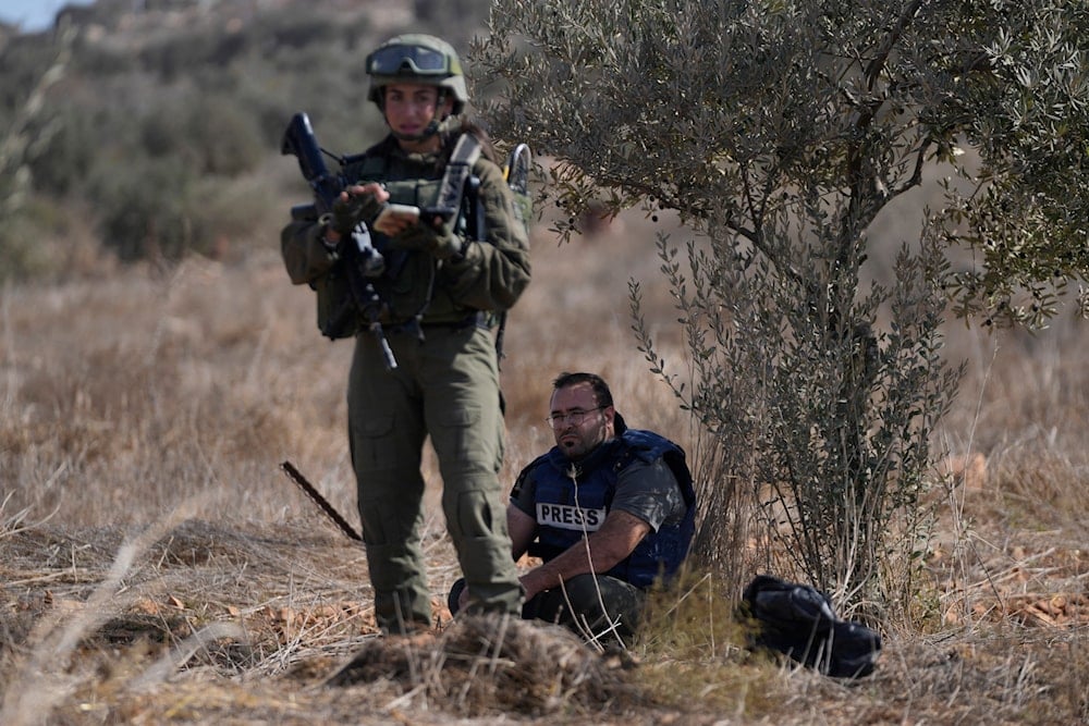 Israeli army troops temporarly detain Palestinian journalist Hesham Abu Shaqra, who was later released,  in the West Bank town of Qusra, south of Nablus Tuesday, Oct. 29, 2024 (AP)
