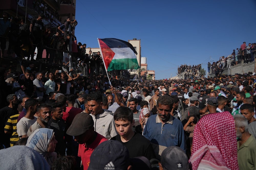 People gather to greet freed Palestinian prisoners as they arrive in the Gaza Strip after their release from Israeli jails under a ceasefire agreement, outside Nasser Hospital in Khan Younis, southern Gaza Strip, Monday, Oct. 13, 2025 (AP)