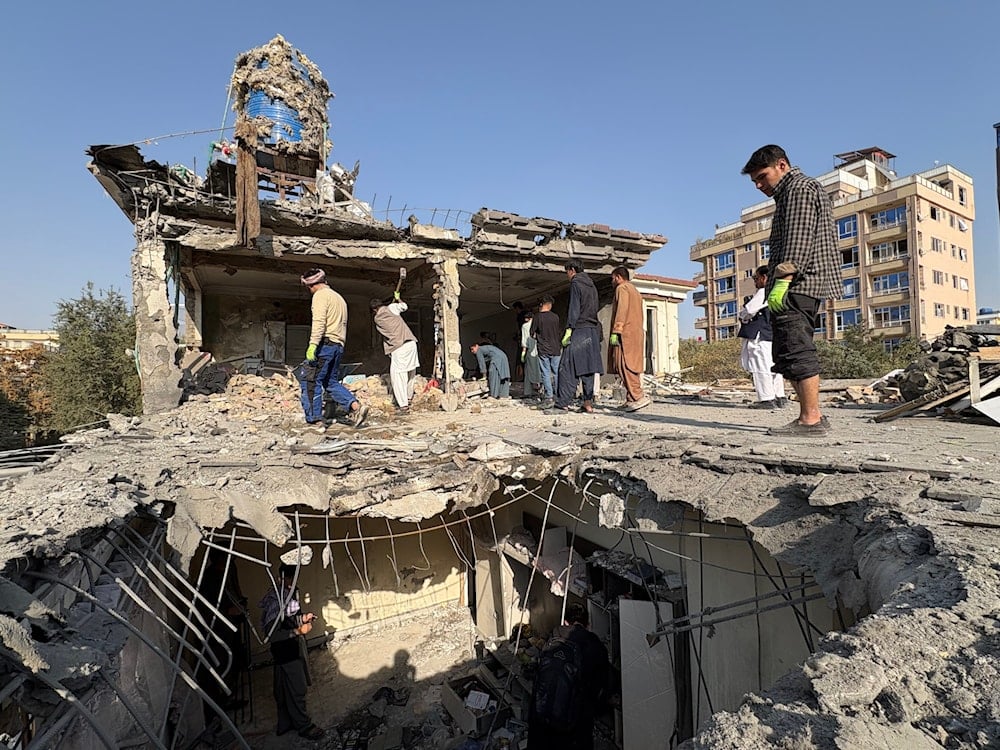 Residents remove debris from a house damaged by Wednesday's two drone strikes, in Kabul, Afghanistan, Thursday, Oct. 16, 2025 (AP)