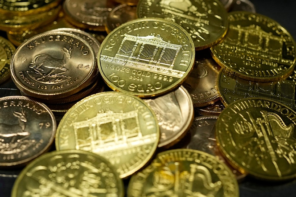 1 Ounce Fine Gold Coins are displayed in the safe deposit boxes room at the Pro Aurum gold house in Munich, Germany, Friday, April 25, 2025. (AP Photo/Matthias Schrader)