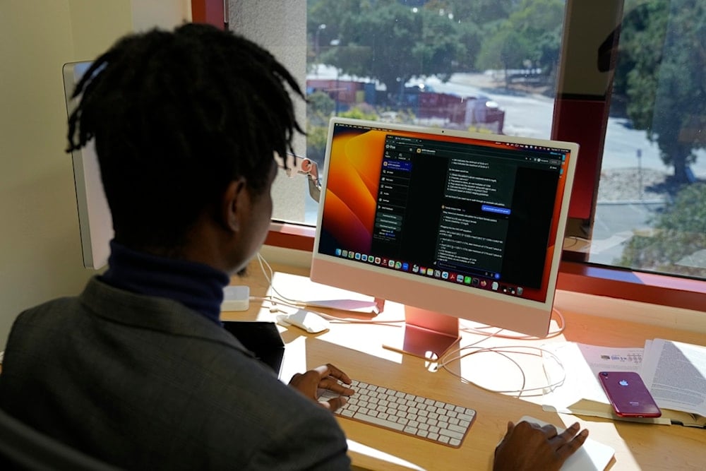 Post-doctoral researcher Tofunmi Omiye looks over chatbots in his office at the Stanford School of Medicine in Stanford, Calif., Tuesday, October 17, 2023. (AP Photo/Eric Risberg)