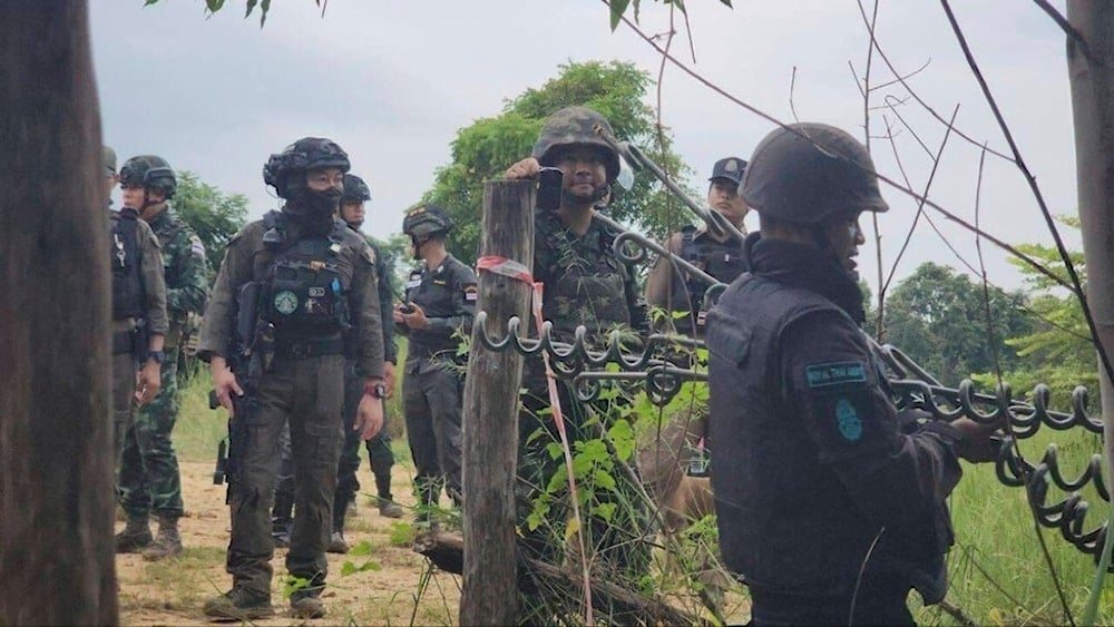 In this photo released by Agence Kampuchea Press (AKP), Thai soldiers gather in Prey Chan village, along the disputed border with Thailand, Wednesday, Sept. 17, 2025. (AKP via AP)