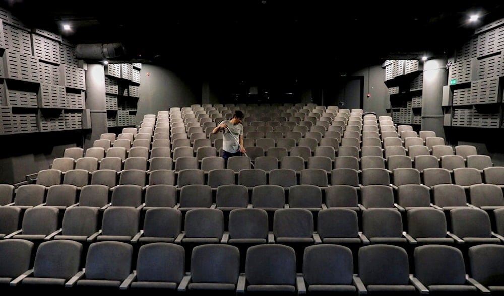 In this Monday, March 16, 2020 photo, a worker cleans an empty and closed cinema hall in Tehran, Iran (AP)