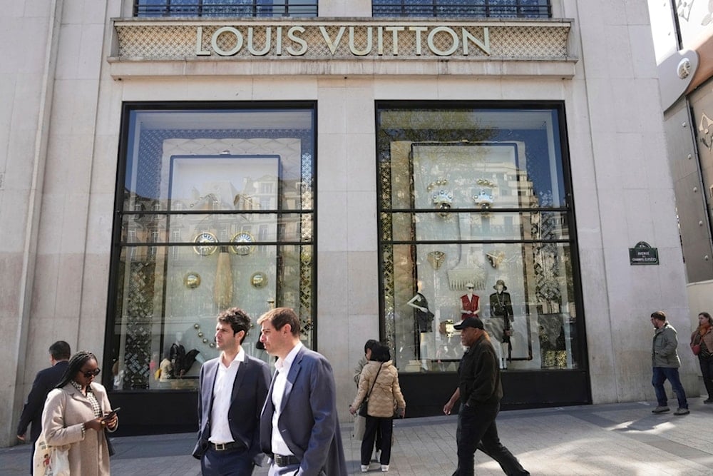 People walk by the Louis Vuitton flagship store on Wednesday, April 9, 2025 in Paris (AP)