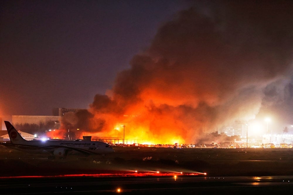 Fire and smoke are visible in the cargo area of Hazrat Shahjalal International Airport in Dhaka, Bangladesh, Saturday, October 18, 2025. (AP Photo/Rajib Dhar)