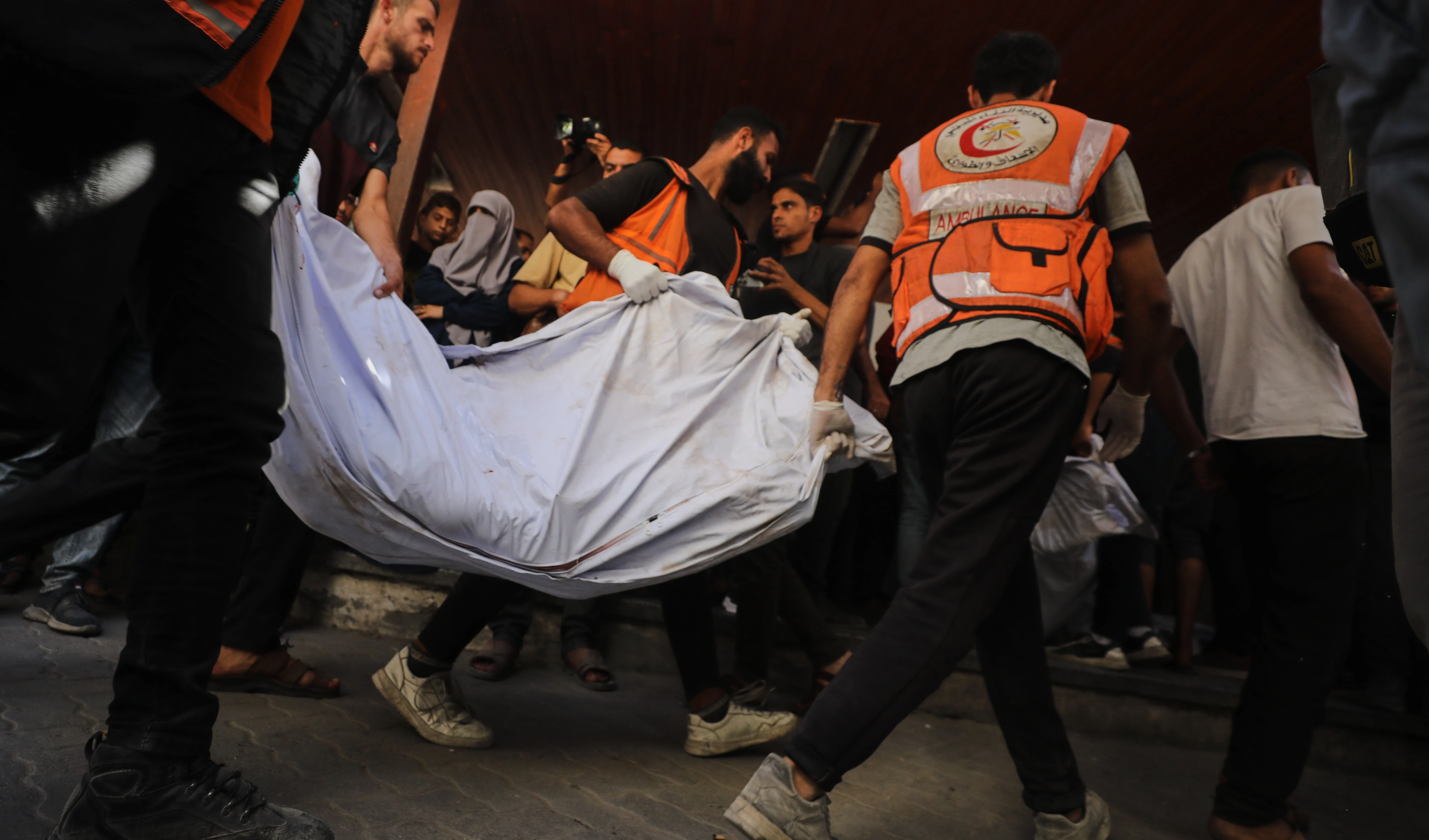 The bodies of Palestinians, killed by Israeli fire after crossing the ceasefire line according to the Hamas-run Civil Defense, are brought to Al Ahli Hospital in Gaza City, on October 18, 2025. (AP Photo/Yousef Al Zanoun)