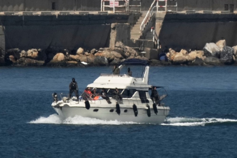 IIsraeli navy soldiers sail one of the boats from the Gaza-bound civilian flotilla Sumud toward the port of Ashdod, Israel, Thursday, Oct. 2, 2025 (AP)