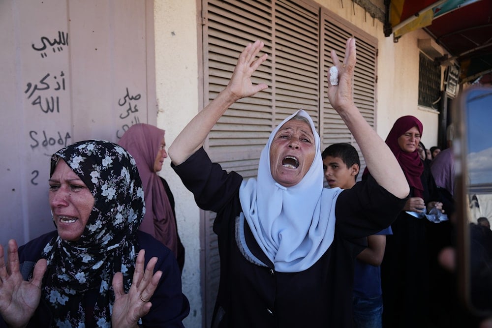Palestinians mourn during the funeral of their relatives who were killed in an Israeli airstrike on Deir al-Balah, central Gaza Strip, Wednesday, Oct. 1, 2025 (AP)