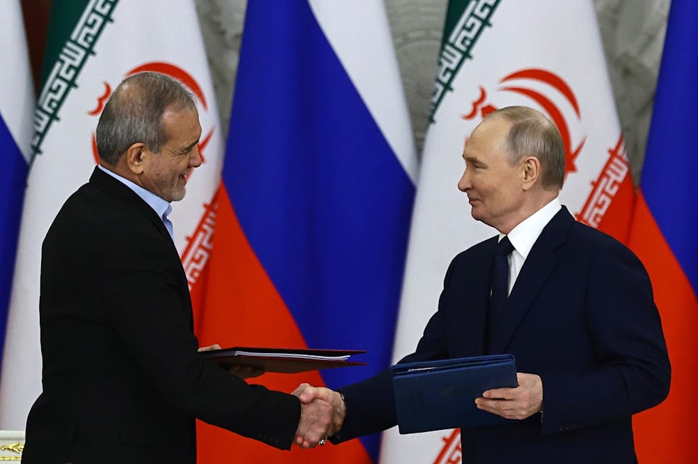 Russian President Vladimir Putin, right, and Iranian President Masoud Pezeshkian attend a signing ceremony at the Kremlin in Moscow, Russia, Friday, Jan. 17, 2025 (AP)