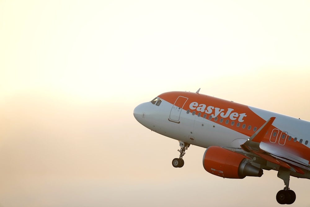 An easyJet Airbus A320 takes off from Lisbon at sunrise, Thursday, Sept. 28, 2023 (AP)