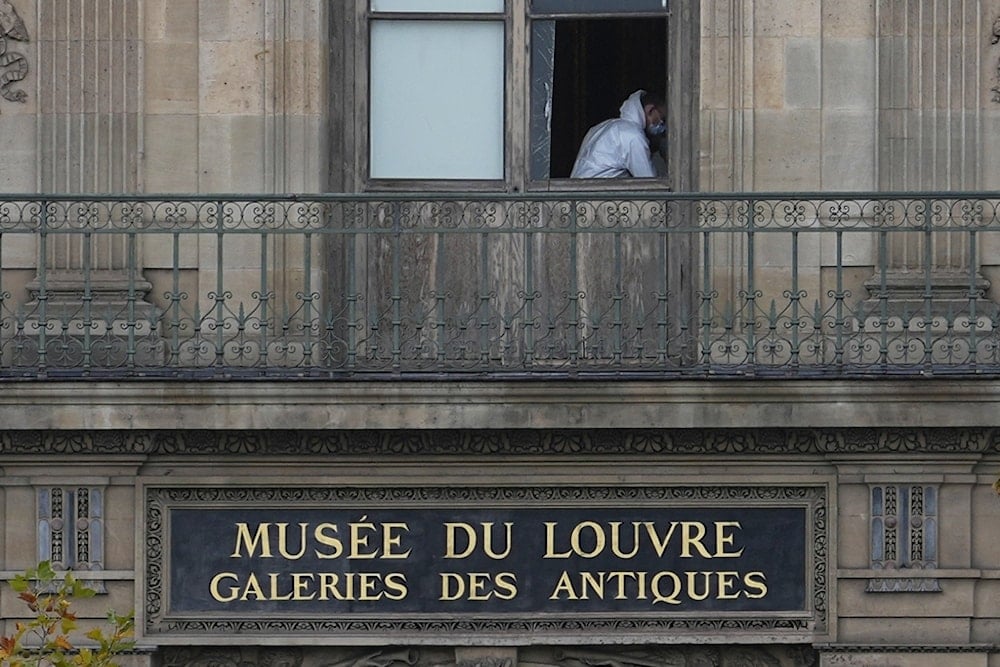 A police officer works inside the Louvre museum, Sunday, Oct. 19, 2025 in Paris. (AP Photo/Thibault Camus)