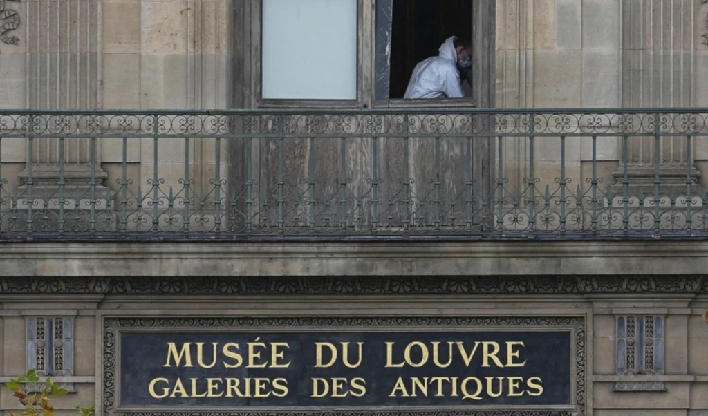 A police officer works inside the Louvre museum, Sunday, Oct. 19, 2025 in Paris. (AP Photo/Thibault Camus)