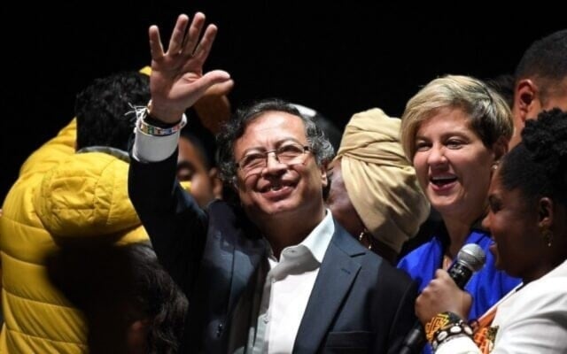 Colombian President Gustavo Petro (C) celebrates his election win next to his wife Veronica Alcocer and his running mate Francia Marquez at the Movistar Arena in Bogota, on June 19, 2022 (AP)