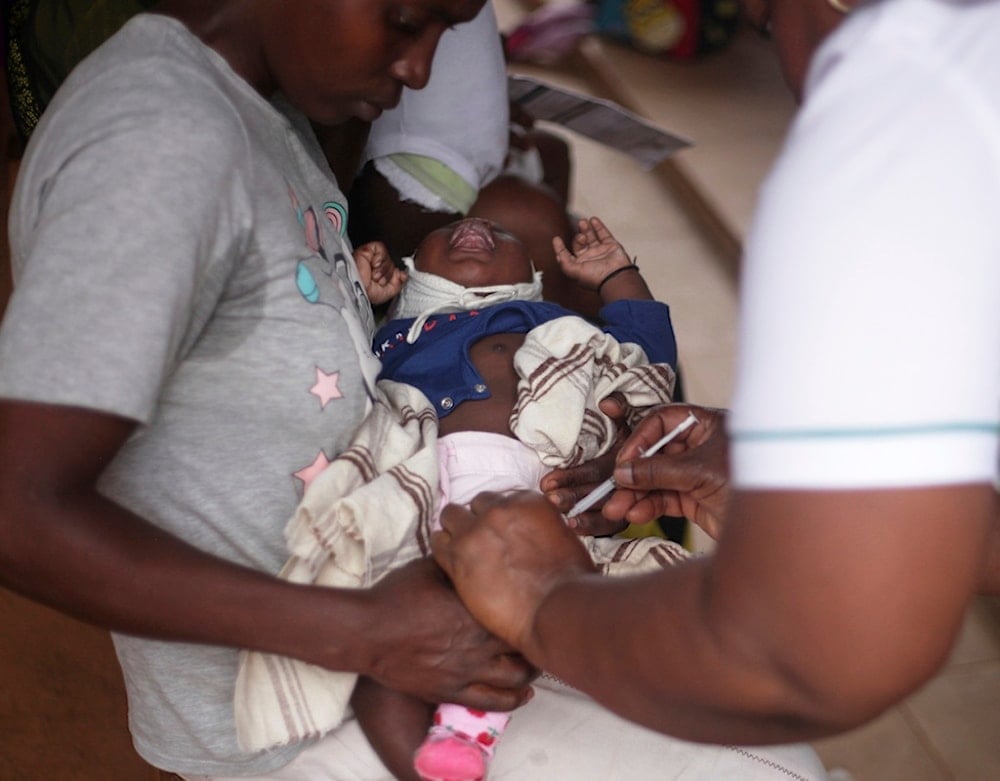 A child receives a vaccine shot at Wakiso Health Centre IV in Wakiso, Uganda, Wednesday, July 23, 2025. (AP Photo/Patrick Onen)