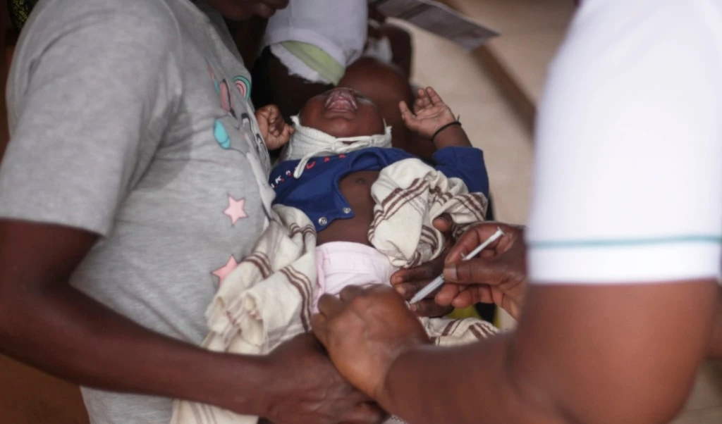 A child receives a vaccine shot at Wakiso Health Centre IV in Wakiso, Uganda, Wednesday, July 23, 2025. (AP Photo/Patrick Onen)