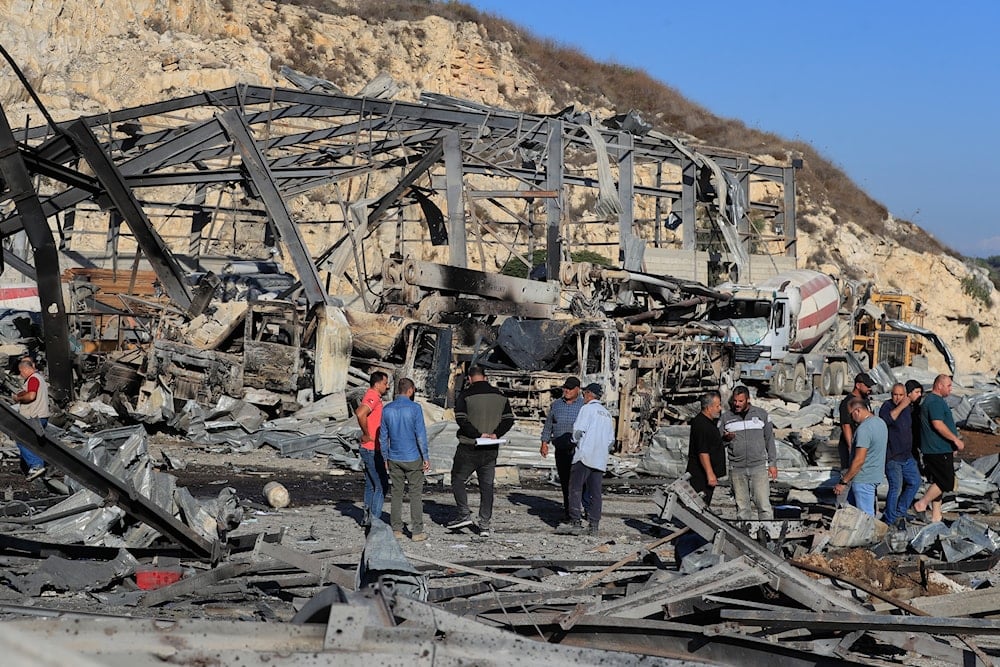 People inspect the site of an Israeli airstrike on a cement plant in the southern Lebanese village of Ansar, Lebanon, Friday, Oct. 17, 2025 (AP)