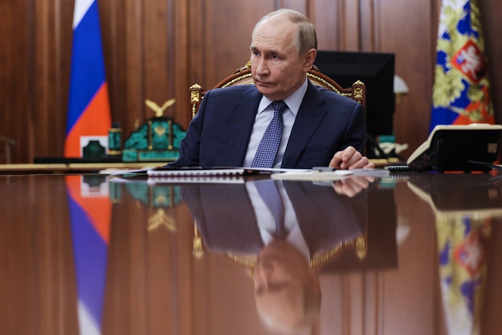 Russian President Vladimir Putin listens to the head of the Federal Service for Supervision of Natural Resources (Rosprirodnadzor) Svetlana Radionova during their meeting at the Kremlin in Moscow, Russia, on Tuesday, Oct. 21, 2025 (AP)