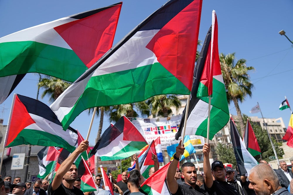 Palestinians fly their flags during a rally in support for Gaza and celebrating the latest recognitions of the Palestinian state ahead of the United Nations General Assembly meetings, West Bank, Ramallah, Occupied Palestine, Sept. 23, 2025 (AP)