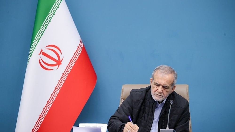 Image of Iranian President Masoud Pezeshkian writing documents in an undated photo (president.ir)