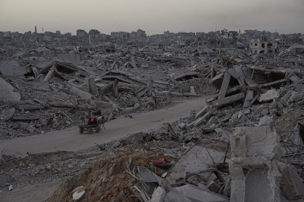 Palestinians travel by horse cart amid the destruction caused by the Israeli war on Gaza in Sheikh Radwan neighborhood in Gaza City, Wednesday, Oct. 22, 2025 (AP)
