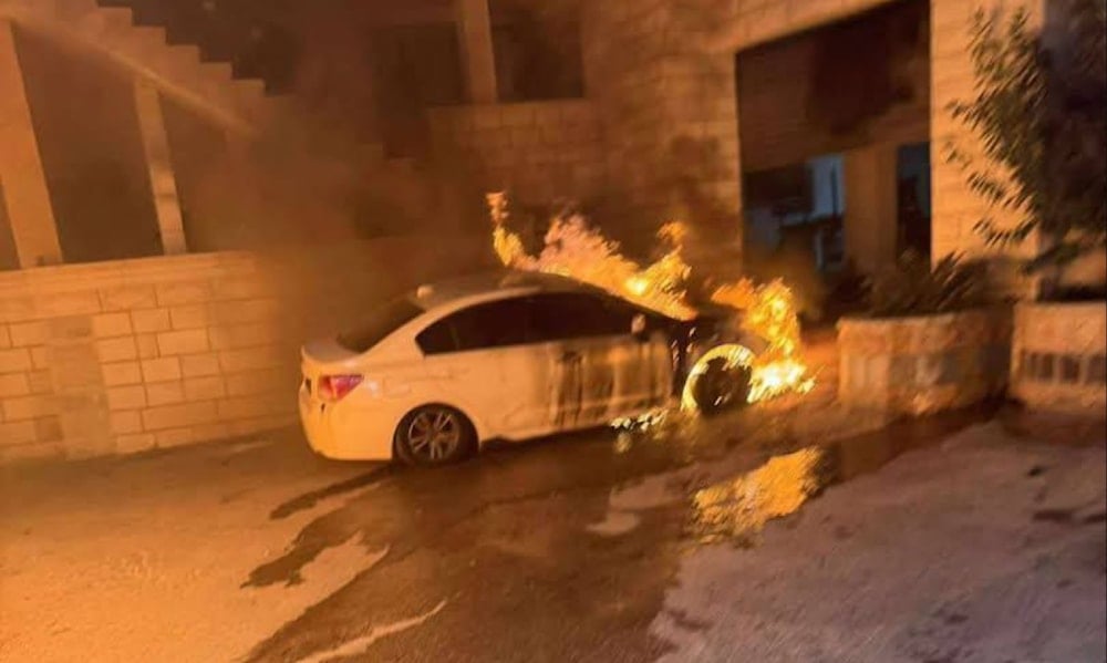 Israeli settlers set fire to Palestinian vehicles in Deir Dibwan, near Ramallah, during a pre-dawn raid. (social media)