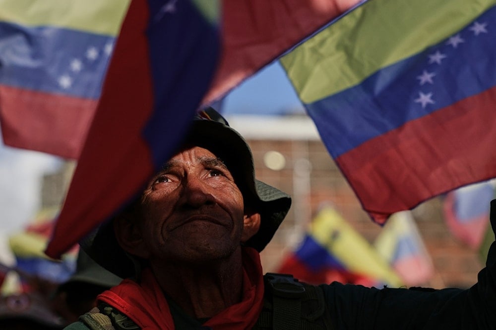 A member of Bolivarian Militia marches in support of President Nicolas Maduro in Caracas, Venezuela, Tuesday, Sept. 23, 2025. (AP Photo/Jesus Vargas)