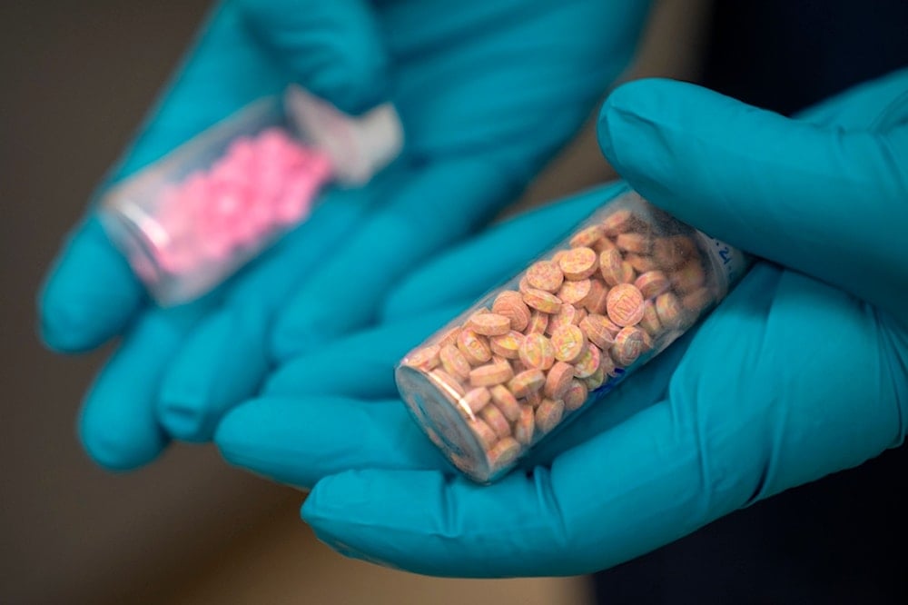Jonathan Dumke, a senior forensic chemist with the Drug Enforcement Administration, holds vials of fentanyl pills at a DEA research laboratory on Tuesday, April 29, 2025, in Northern Virginia (AP)