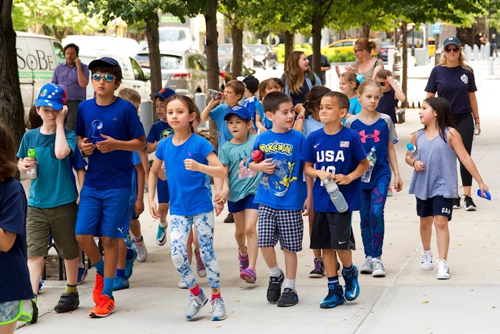 Children walk along a sidewalk, Thursday, June 15, 2017 in New York. (AP)