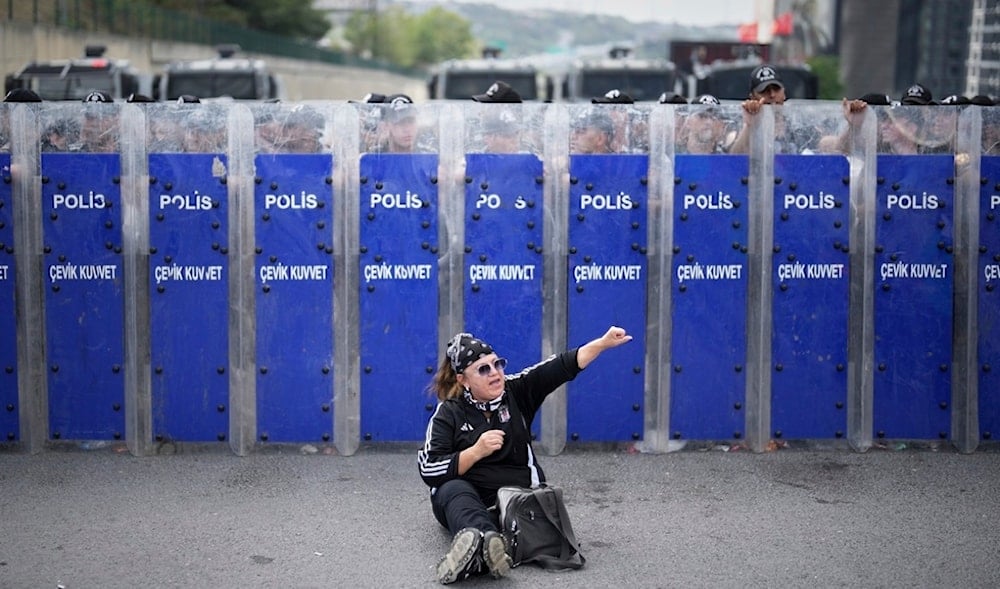 Riot police hold their shields as a supporter of Turkey's main opposition CHP shouts slogans during a demonstration outside the party's headquarters in Istanbul, Sept. 8, 2025. (AP)