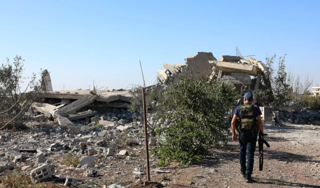 A gunman walks by the remains of a house destroyed during the recent sectarian clashes in the Druze-majority town of Sweida, southern Syria, on September 19, 2025. (AP Photo/Fahd Kiwan) A gunman walks by the remains of a house destroyed during the recent sectarian clashes in the Druze-majority town of Sweida, southern Syria, on September 19, 2025. (AP Photo/Fahd Kiwan)