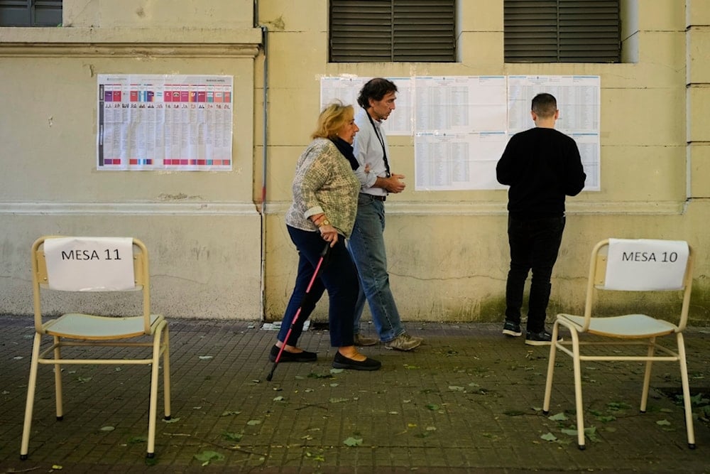 Voters arrive at a polling station during legislative midterm elections, in La Plata, Argentina, Sunday, Oct. 26, 2025. (AP Photo/Gustavo Garello)