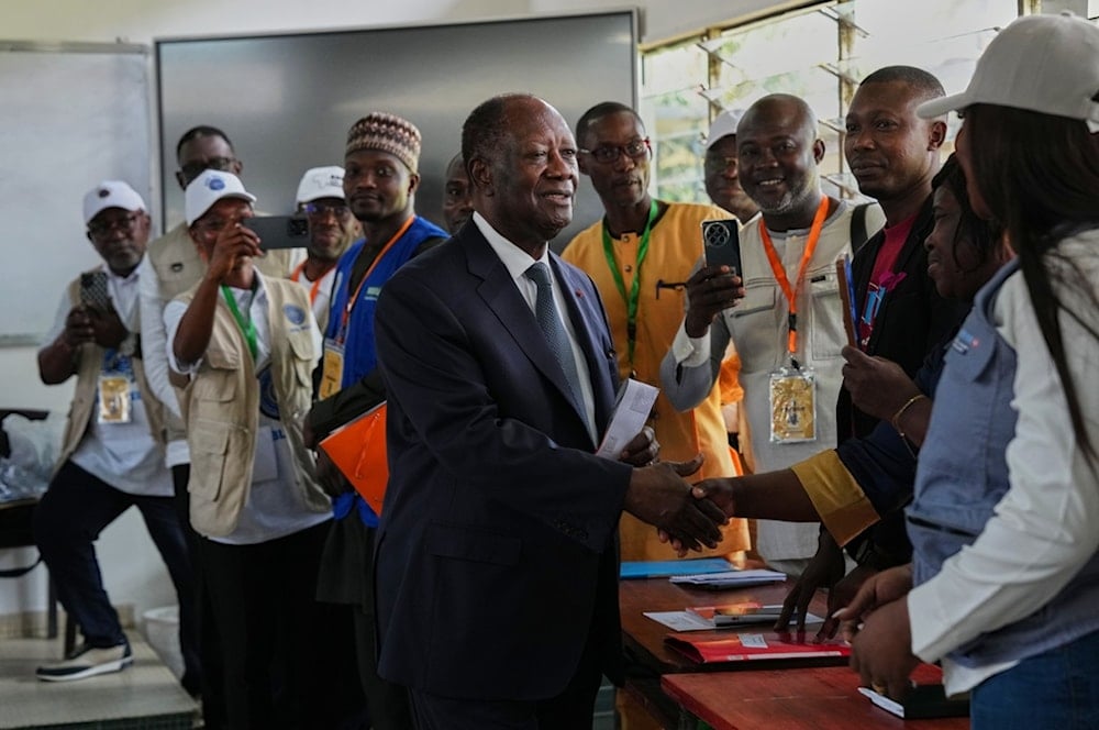 Ivory Coast President Alassane Ouattara arrives to cast his vote at a polling station during the presidential elections in Abidjan, Ivory Coast, Saturday, Oct. 25, 2025. (AP Photo/Misper Apawu)