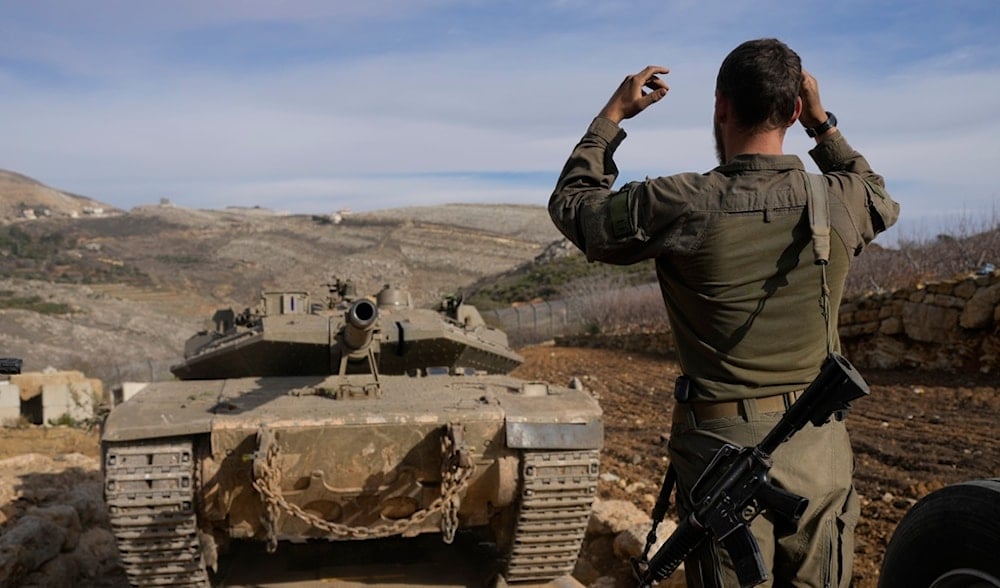 An Israeli soldier loads a tank near the so-called Alpha Line that separates the Israeli-annexed Golan Heights from Syria, in the town of Majdal Shams, Dec. 11, 2024. (AP)