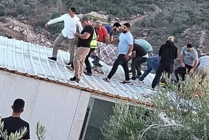 Lebanese residents lift a man after he was martyred in an Israeli airstrike on Al Bayadh, Lebanon, October 27, 2925 (social media)