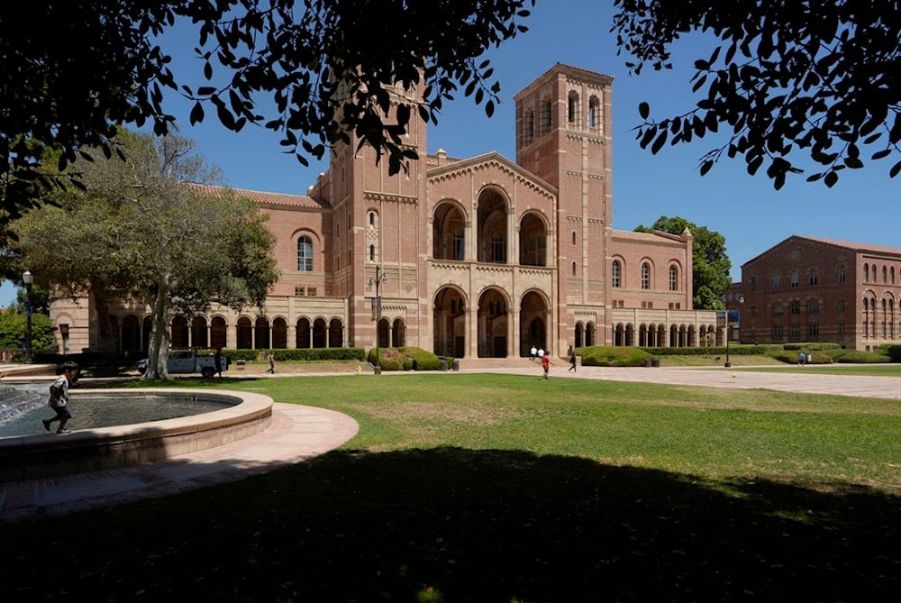 Children play outside Royce Hall at the University of California, Los Angeles, campus in Los Angeles, August 15, 2024. (AP Photo/Damian Dovarganes)