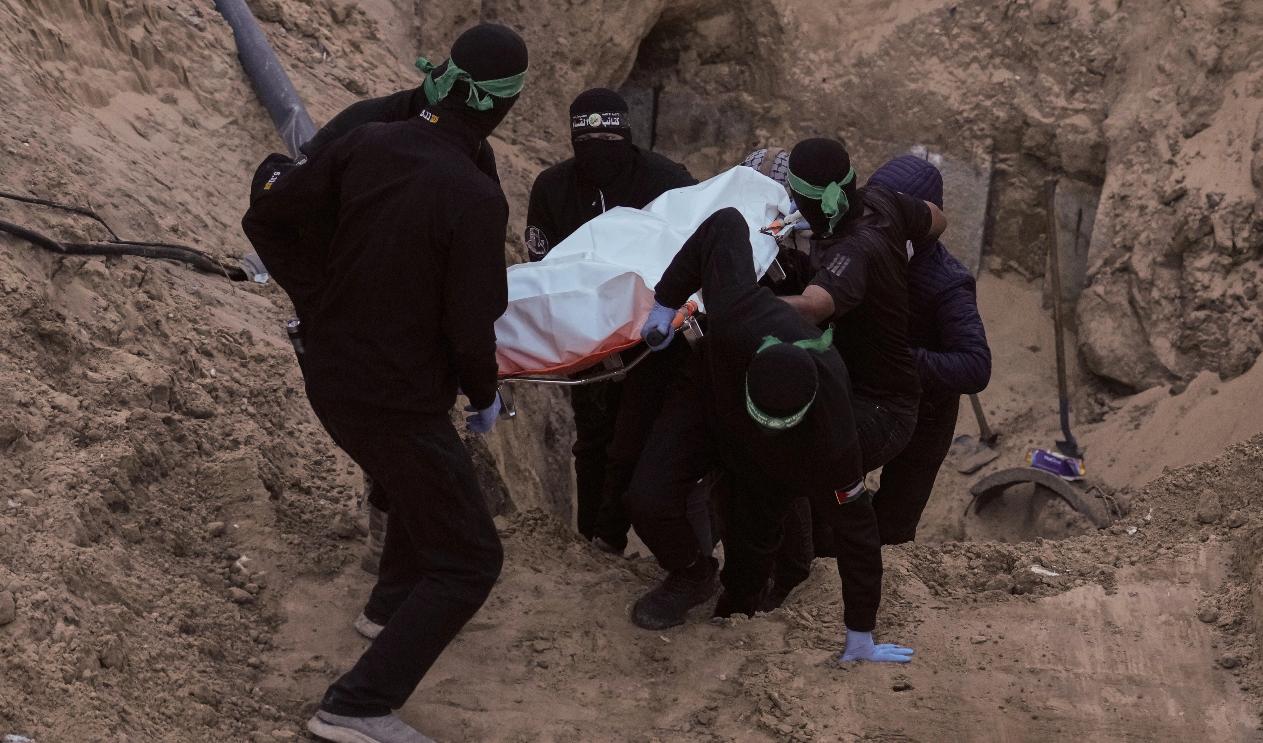 Al-Qassam Brigades fighters carry a white bag believed to contain a body, retrieved from a tunnel during a search for the remains of Israeli captives in Hamad City, Khan Younis, southern Gaza, Tuesday, Oct. 28, 2025 (AP) Al-Qassam Brigades fighters carry a white bag believed to contain a body, retrieved from a tunnel during a search for the remains of Israeli captives in Hamad City, Khan Younis, southern Gaza, Tuesday, Oct. 28, 2025 (AP)