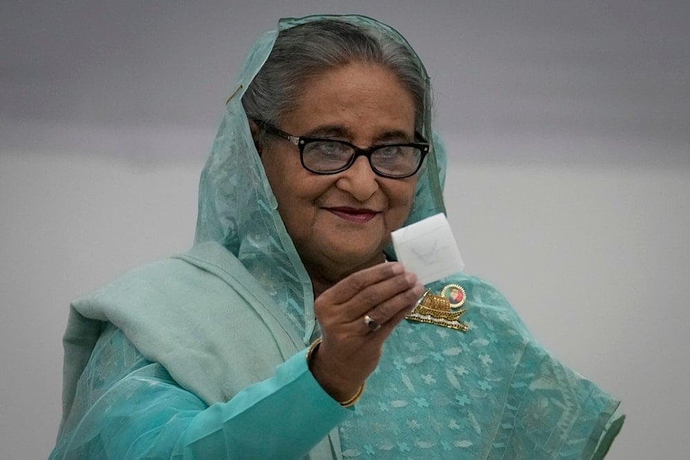 Bangladesh Prime Minister Sheikh Hasina shows her ballot paper as she casts her vote in Dhaka, Bangladesh, Sunday, January 7, 2024. (AP Photo/Altaf Qadri, File)