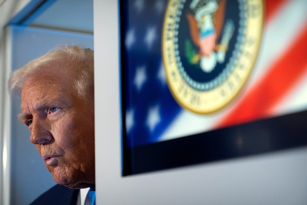 President Donald Trump speaks to reporters aboard Air Force One as he travels from Tokyo, Japan, to South Korea, on October 29, 2025. (AP Photo/Mark Schiefelbein)