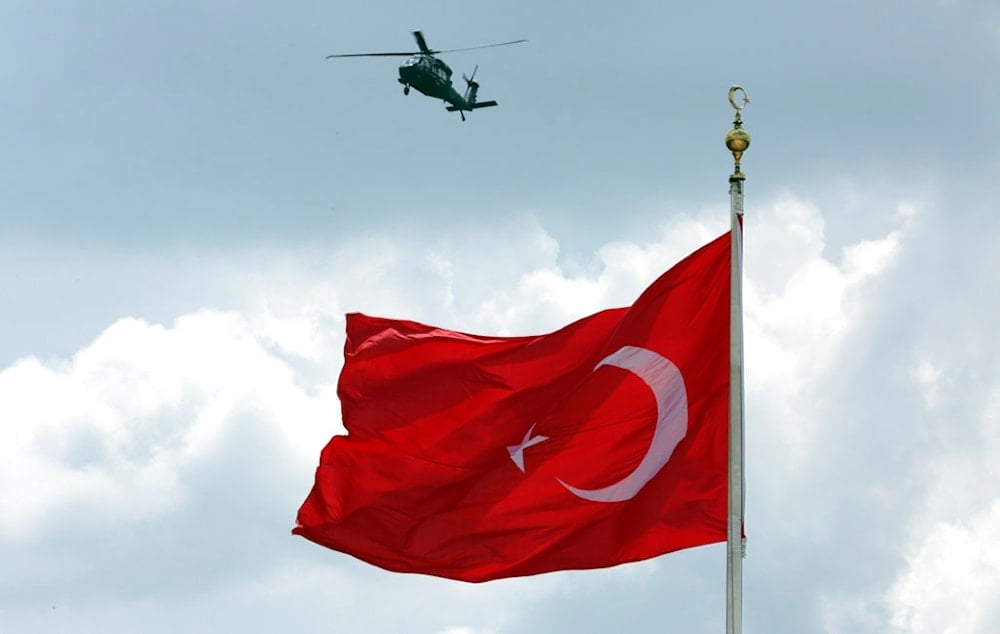 A military helicopter flies over as Turkey's President Recep Tayyip Erdogan visits the mausoleum of Mustafa Kemal Ataturk, founder of modern Turkey, in Ankara, Turkey, Thursday, Aug. 2, 2018.