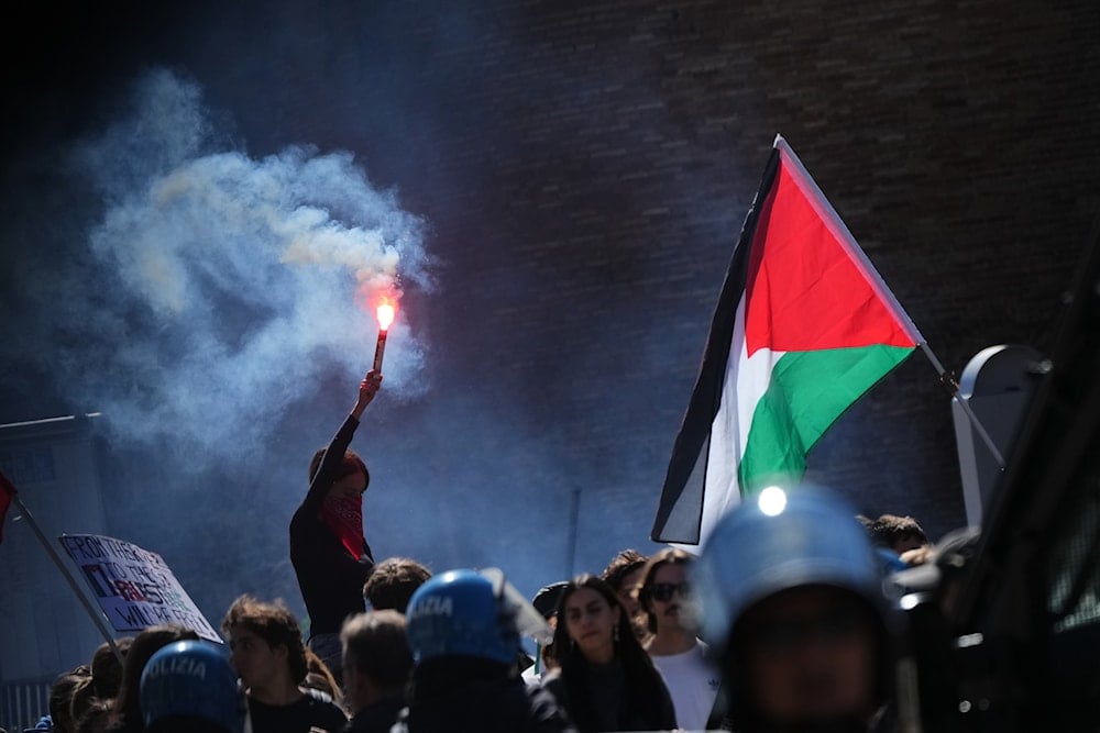 Pro-Palestinian demonstrators gather for a national general strike called by unions to protest against the situation in Gaza two days after 'Israel' intercepted a Gaza-bound aid flotilla in the Mediterranean Sea, in Rome, Friday, Oct. 3, 2025 (AP)