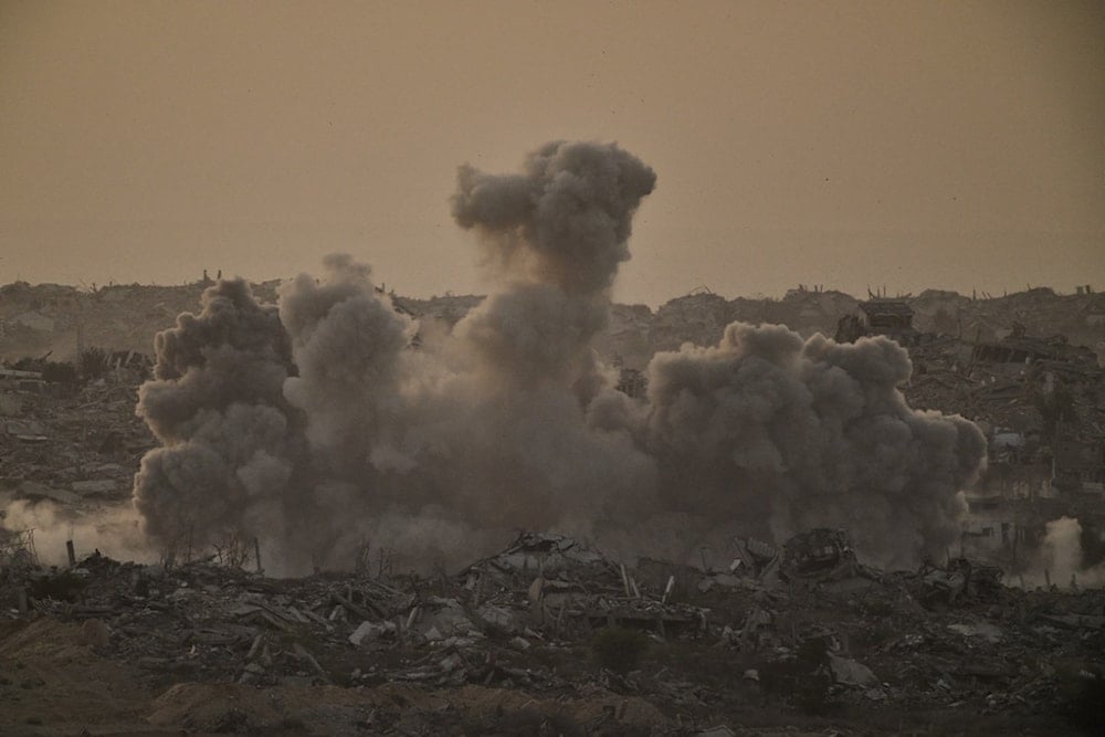 Buildings that were destroyed during the Israeli ground and air operations are engulfed by smoke following an Israeli military strike in the northern Gaza Strip, as seen from southern occupied Palestine, Friday, October 3, 2025 (AP)