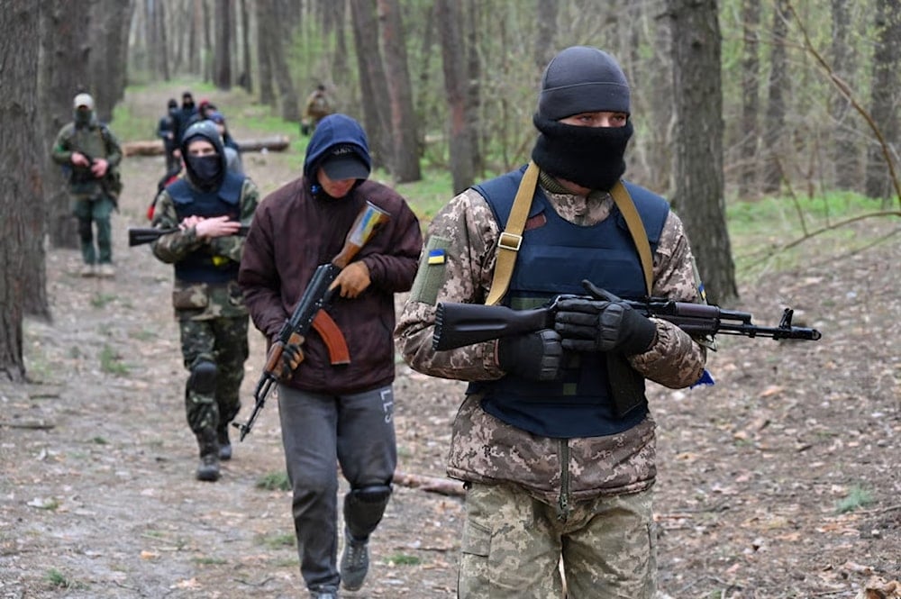 People take part in the combat training course at the recruiting center of the Ukrainian Armed Forces in Kharkiv on April 14, 2022 (Sergey Bobok/AFP via Getty Images)
