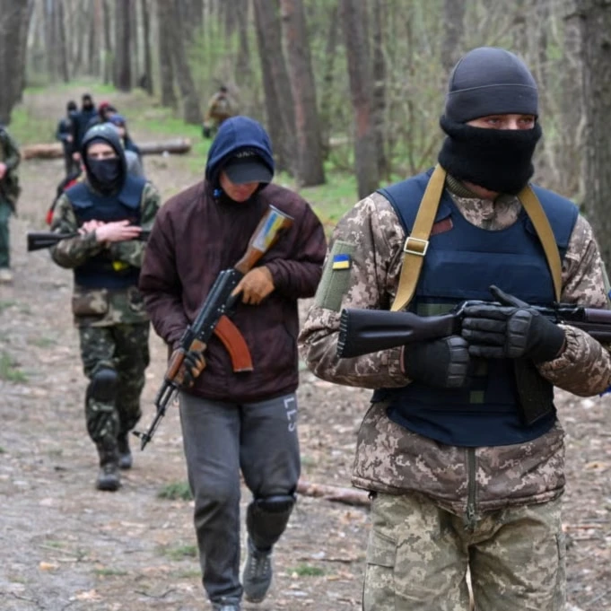 People take part in the combat training course at the recruiting center of the Ukrainian Armed Forces in Kharkiv on April 14, 2022 (Sergey Bobok/AFP via Getty Images)