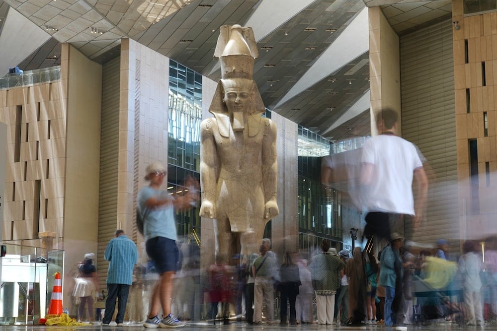 Tourists view the statue of Pharaoh Ramesses II on May 23, 2025 (Amr Nabil/AP)