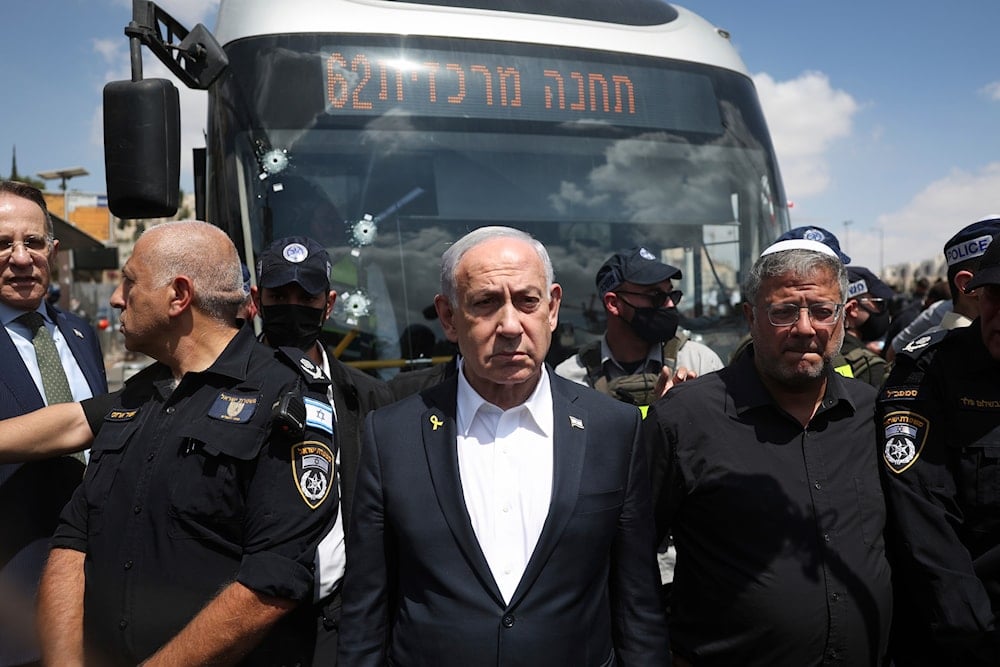 Israeli Prime Minister Benjamin Netanyahu and Police Minister Itamar Ben-Gvir, right, visit the site of a shooting attack at a bus stop in al-Quds, Occupied Palestine, Monday, Sept. 8, 2025 (AP)