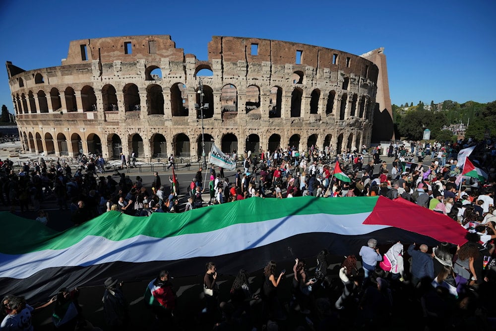 Pro-Palestinian demonstrators march in front of the Colosseum during a national demonstration in support of the population of Gaza, in Rome, Saturday, Oct. 4, 2025 (AP)